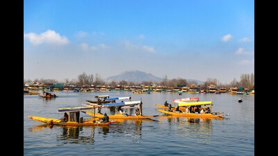 Tourists enjoying a shikara ride at Dal Lake on a sunny day in Srinagar on Sunday. (ANI)