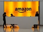 In this photo, people stand in the lobby for Amazon offices in New York