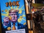 A cartoon image of US President-elect Donald Trump holding a Bitcoin token to mark the cryptocurrency reaching over $100,000 displayed at a Coinhero store in Hong Kong, China, on in Hong Kong, China, on Thursday, Dec. 5, 2024. Trump's pick of a crypto proponent to be the next head of the US securities regulator lifted Bitcointo $100,000 for the first time as traders warmed to the prospect of relaxed regulations.