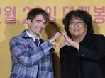 Director Bong Joon-ho, right, and actor Robert Pattinson, pose for the media ahead of a news conference for "Mickey 17" in Seoul, South Korea, Monday, Jan. 20, 2025. (AP Photo/Lee Jin-man)