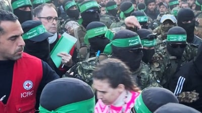 Palestinian Hamas militants hand over Doron Steinbrecher, a hostage who had been held in Gaza since the deadly October 7 2023 attack, to members of the International Committee of the Red Cross (ICRC) as part of the ceasefire. (REUTERS)