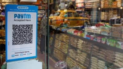 Paytm Q3 2025 results: A QR code sticker of the digital payment app Paytm is seen outside a grocery store in Kolkata, India. (Reuters)