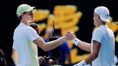 Italy's Jannik Sinner shakes hands with Denmark's Holger Rune after winning his fourth round match (REUTERS)