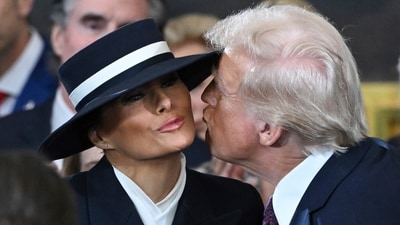 President-elect Donald Trump tries to kiss Melania Trump before the 60th Presidential Inauguration in the Rotunda of the US Capitol in Washington. (AP) President-elect Donald Trump tries to kiss Melania Trump before the 60th Presidential Inauguration in the Rotunda of the US Capitol in Washington. (AP)