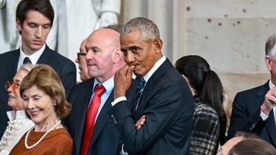 Former President Barack Obama, right, and Laura Bush, left, attend the 60th Presidential Inauguration in the Rotunda of the US Capitol in Washington. (AP) Former President Barack Obama, right, and Laura Bush, left, attend the 60th Presidential Inauguration in the Rotunda of the US Capitol in Washington. (AP)