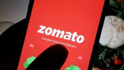 The logo of Indian food delivery company Zomato is seen on its app on a mobile phone displayed in front of its company website in this illustration picture taken July 14, 2021 (Florence Lo/Reuters)