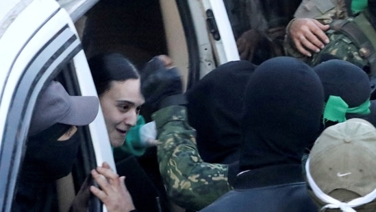Thousands of Israelis celebrated, hugged, or sobbed in a plaza when the three female captives emerged from a car flanked by armed Hamas members on a huge screen outside the defence headquarters in Tel Aviv.(REUTERS/Dawoud Abu Alkas)
