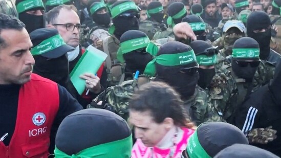 Palestinian Hamas militants hand over Doron Steinbrecher, a hostage who had been held in Gaza since the deadly October 7 2023 attack, to members of the International Committee of the Red Cross (ICRC) as part of the ceasefire.(REUTERS)