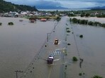 A drone view shows vehicles driving in an area flooded after heavy rains, in Tijucas, in Santa Catarina state, Brazil January 17, 2025. REUTERS/Anderson Coelho