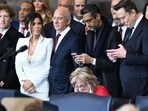Elon Musk and Sundar Pichai looking at thier phones. Elon Musk and Sundar Pichai looking at thier phones.