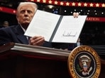 President Donald Trump signs an executive order as he attends an indoor Presidential Inauguration parade event at Capital One Arena in Washington. President Donald Trump signs an executive order as he attends an indoor Presidential Inauguration parade event at Capital One Arena in Washington.
