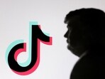 A 3D-printed miniature model of US President Donald Trump and TikTok logo are seen in this illustration. 