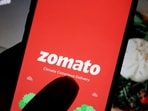 Zomato share price: The logo of Indian food delivery company Zomato is seen on its app on a mobile phone displayed in front of its company website in this illustration picture taken July 14, 2021