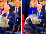Joe Biden quickly made the sign of the cross and smiled while sitting at the inauguration dais.