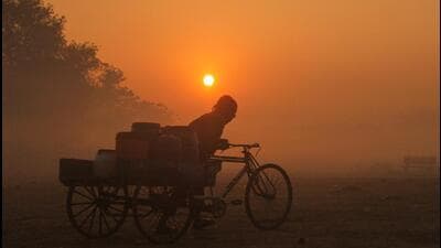 A commuter on his way amid dense fog on a cold winter morning in Gurugram on Tuesday. (ANI)