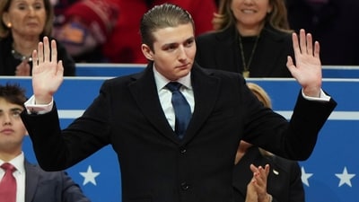 Barron Trump waves at an indoor Presidential Inauguration parade event in Washington. (AP) Barron Trump waves at an indoor Presidential Inauguration parade event in Washington. (AP)