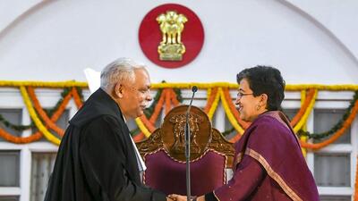 CM Atishi with Justice Devendra Kumar Upadhyaya after the latter took oath on Tuesday. CM Atishi with Justice Devendra Kumar Upadhyaya after the latter took oath on Tuesday.