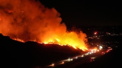 Vehicles drive along Interstate 15 as the Lilac Fire burns along a hillside in Bonsall, California on January 21. The weather service has issued a warning of a “ particularly dangerous situation ” for parts of Los Angeles, Ventura and San Diego counties from Monday afternoon to Tuesday morning due to low humidity and damaging Santa Ana winds. (AP) Vehicles drive along Interstate 15 as the Lilac Fire burns along a hillside in Bonsall, California on January 21. The weather service has issued a warning of a “ particularly dangerous situation ” for parts of Los Angeles, Ventura and San Diego counties from Monday afternoon to Tuesday morning due to low humidity and damaging Santa Ana winds. (AP)