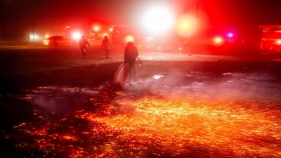 A firefighter extinguishes a brush fire as strong winds carry embers in the Winchester community of unincorporated Riverside County in California on January 20. Two new wildfires broke in San Diego County in Southern California as powerful Santa Ana winds picked up pace on Tuesday. (AP) A firefighter extinguishes a brush fire as strong winds carry embers in the Winchester community of unincorporated Riverside County in California on January 20. Two new wildfires broke in San Diego County in Southern California as powerful Santa Ana winds picked up pace on Tuesday. (AP)