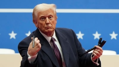 President Donald Trump throws pens used to sign executive orders to the crowd during an indoor Presidential Inauguration parade event in Washington, Monday, Jan. 20, 2025. (AP Photo/Matt Rourke) (AP) President Donald Trump throws pens used to sign executive orders to the crowd during an indoor Presidential Inauguration parade event in Washington, Monday, Jan. 20, 2025. (AP Photo/Matt Rourke) (AP)