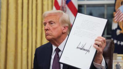 U.S. President Donald Trump holds a document on the day he issues executive orders in the Oval Office at the White House on Inauguration Day in Washington on January 20. (REUTERS) U.S. President Donald Trump holds a document on the day he issues executive orders in the Oval Office at the White House on Inauguration Day in Washington on January 20. (REUTERS)