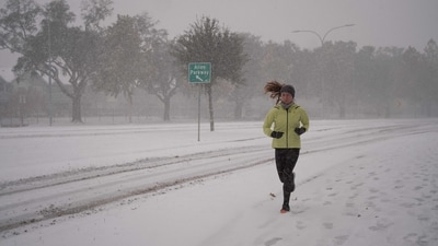 A woman runs along Allen Parkway near downtown winter storm Enzo brings heavy bands of snow and sleet on January 21, 2025 in Houston, Texas.&nbsp; (Getty Images via AFP)
