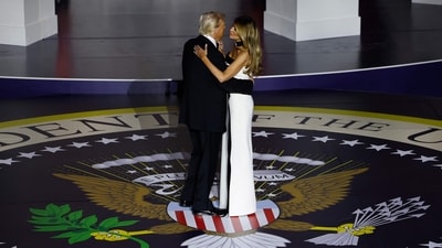 Melania Trump danced with Donald Trump in a black and white floor-length dress at the Inauguration Ball. The strapless ensemble features a square neckline, a contrasting black zig-zag detailing cascading through the length of the gown, a front thigh-high slit, a figure-hugging silhouette, and a floor-grazing length. (Getty Images via AFP) Melania Trump danced with Donald Trump in a black and white floor-length dress at the Inauguration Ball. The strapless ensemble features a square neckline, a contrasting black zig-zag detailing cascading through the length of the gown, a front thigh-high slit, a figure-hugging silhouette, and a floor-grazing length. (Getty Images via AFP)