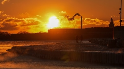 A couple take a walk at sunrise near the icy Oak Street Beach along the shore of Lake Michigan Monday, Jan. 20, 2025, in Chicago, as the weather service issued cold weather advisories across the Great Lakes region as high temperatures in many places were expected only to rise into the single digits Monday and Tuesday. (AP/Kiichiro Sato) A couple take a walk at sunrise near the icy Oak Street Beach along the shore of Lake Michigan Monday, Jan. 20, 2025, in Chicago, as the weather service issued cold weather advisories across the Great Lakes region as high temperatures in many places were expected only to rise into the single digits Monday and Tuesday. (AP/Kiichiro Sato)