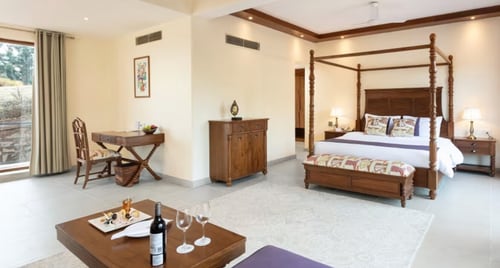 The rooms have a rustic charm with wooden furniture. (PC: Suryavilas Gallery)