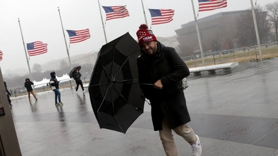 A destructive winter storm is expected to hit sections of the South on Monday as an arctic air mass that is sweeping across the eastern, central, and parts of the western U.S. channels temperatures 20 to 30 degrees below the already record January normal. In pic: a man holds an umbrella during cold weather as he visits the National Mall a day before U.S. President-elect Donald Trump is scheduled to be inaugurated for a second term, in Washington, U.S.(REUTERS/Jeenah Moon)
