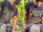 The image shows a snake biting a man’s private parts. 