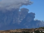 A plume of smoke from the new Hughes fire is seen behind the California State Route 14 highway from Santa Clarita, California, on January 22, 2025. A plume of smoke from the new Hughes fire is seen behind the California State Route 14 highway from Santa Clarita, California, on January 22, 2025.