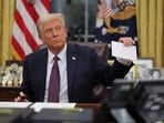 U.S. President Donald Trump holds former United States President Joe Biden's letter on the day he signs documents as he issues executive orders and pardons for January 6 defendants in the Oval Office at the White House on Inauguration Day in Washington, U.S., January 20, 2025.  REUTERS/Carlos Barria