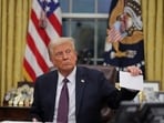 FILE PHOTO: U.S. President Donald Trump holds former United States President Joe Biden's letter on the day he signs documents as he issues executive orders and pardons for January 6 defendants in the Oval Office at the White House on Inauguration Day in Washington, U.S., January 20, 2025.  REUTERS/Carlos Barria/File Photo