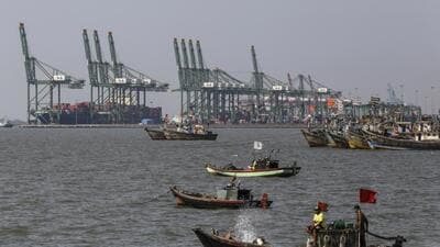 Boats sail past the Jawaharlal Nehru Port in Navi Mumbai, Maharashtra. (Bloomberg)