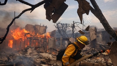 FILE - A firefighter battles the Palisades Fire around a burned structure in the Pacific Palisades neighborhood of Los Angeles, Jan. 8, 2025. (AP Photo/Etienne Laurent, File) (AP) FILE - A firefighter battles the Palisades Fire around a burned structure in the Pacific Palisades neighborhood of Los Angeles, Jan. 8, 2025. (AP Photo/Etienne Laurent, File) (AP)
