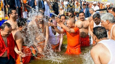 Prayagraj: Uttar Pradesh Chief Minister Yogi Adityanath, with his Cabinet colleagues, takes a holy dip at the Sangam during the Maha Kumbh Mela 2025 in Prayagraj, Uttar Pradesh. (PTI)