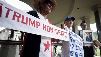 A woman holds up a banner with a message that reads in Spanish; "Trump persona non grata!", during a demonstration marking Martyrs' Day, a national day of mourning to honor the 21 Panamanians who were killed during the January 1964 anti-American riots over sovereignty of the Panama Canal Zone, in Panama City. (AP) A woman holds up a banner with a message that reads in Spanish; "Trump persona non grata!", during a demonstration marking Martyrs' Day, a national day of mourning to honor the 21 Panamanians who were killed during the January 1964 anti-American riots over sovereignty of the Panama Canal Zone, in Panama City. (AP)
