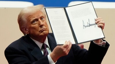US President Donald Trump holds up an executive order after signing it in Washington on Tuesday. (AP) US President Donald Trump holds up an executive order after signing it in Washington on Tuesday. (AP)