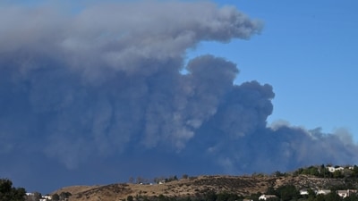 A plume of smoke from the new Hughes fire is seen behind the California State Route 14 highway from Santa Clarita, California, on January 22, 2025. (AFP) A plume of smoke from the new Hughes fire is seen behind the California State Route 14 highway from Santa Clarita, California, on January 22, 2025. (AFP)