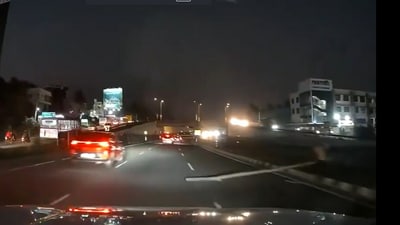 Man placing a wooden log on Bengaluru-Mysuru Expressway. (Screengrab from viral video) Man placing a wooden log on Bengaluru-Mysuru Expressway. (Screengrab from viral video)
