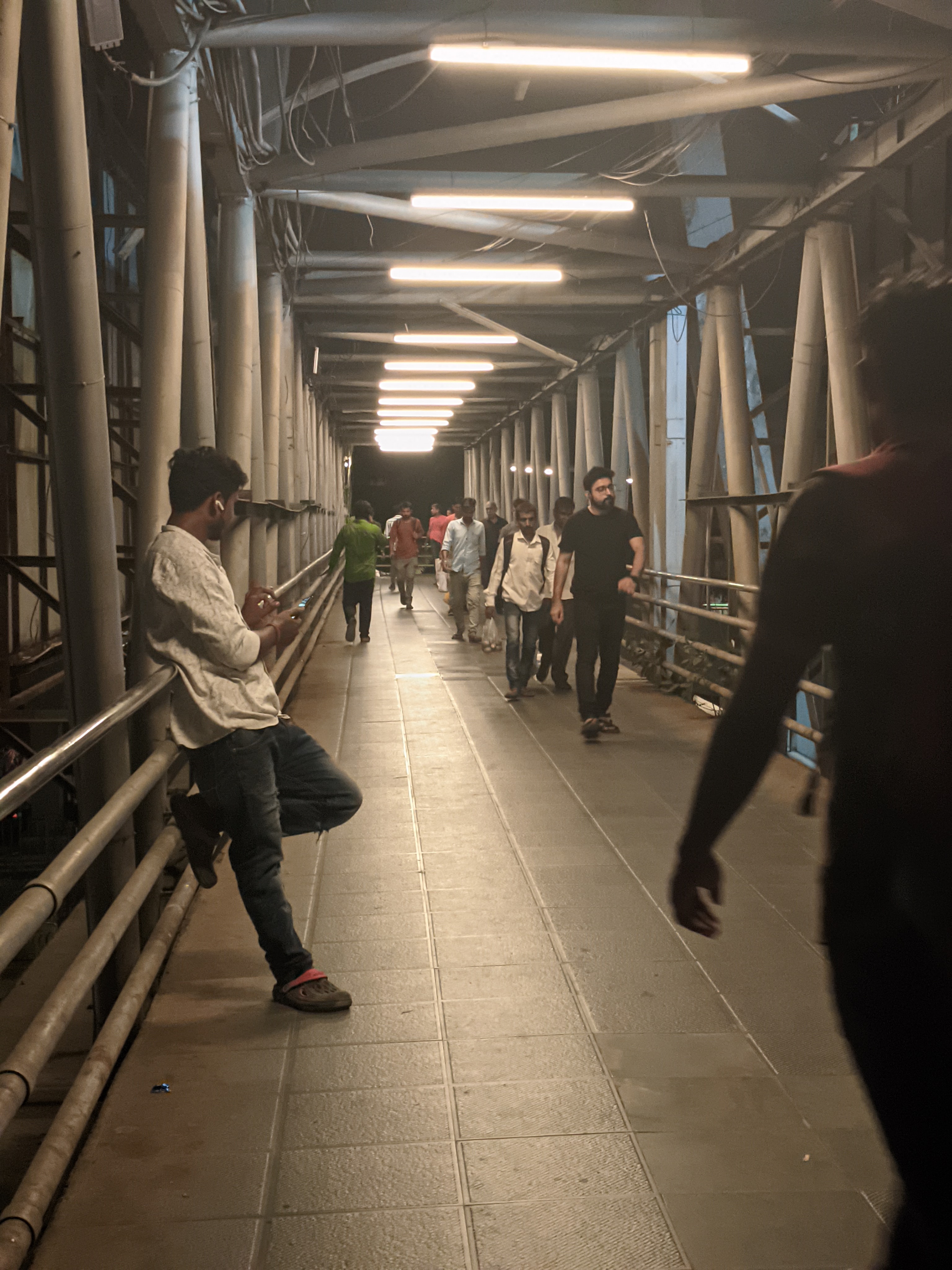 Men walking on an overbridge in Mumbai. (Suhit Bombaywala) Men walking on an overbridge in Mumbai. (Suhit Bombaywala)