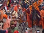 Mahakumbh 2025 live updates: Ash-smeared Naga Sadhus or Hindu holy men (C) of an akhara (monastic Hindu order), walk during a religious procession as they head to take a dip in Sangam, the confluence of Ganges, Yamuna and mythical Saraswati rivers, on the occasion of Maha Kumbh Mela festival, in Prayagraj on January 14.