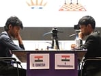 D Gukesh (L) and R Praggnanandhaa (R) face each other during a tournament.