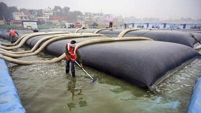A municipal worker at a sewage treatment plant in India. (PTI) A municipal worker at a sewage treatment plant in India. (PTI)