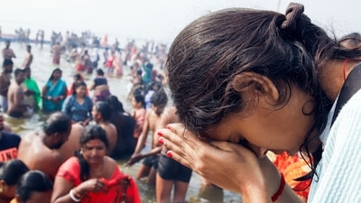 A devotee offers prayers after taking a dip at Triveni Sangam during the Maha Kumbh 2025 in Prayagraj, despite the freezing weather, on Thursday. (ANI) A devotee offers prayers after taking a dip at Triveni Sangam during the Maha Kumbh 2025 in Prayagraj, despite the freezing weather, on Thursday. (ANI)