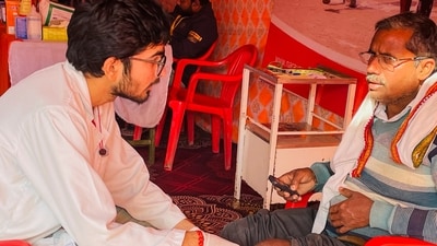 A disabled pilgrim provides measurements for a free artificial limb fitting during the Mahakumbh Mela at Sangam in Prayagraj. (PTI) A disabled pilgrim provides measurements for a free artificial limb fitting during the Mahakumbh Mela at Sangam in Prayagraj. (PTI)