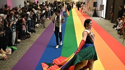 Members of the LGBTQ community walk on a rainbow carpet at a marriage registration event at Paragon shopping mall in Bangkok on January 23, 2025. Almost 2,000 same-sex and transgender couples married in Thailand on January 23 as the kingdom's equal marriage law went into effect in a first for Southeast Asia. (Photo by Lillian SUWANRUMPHA / AFP) Members of the LGBTQ community walk on a rainbow carpet at a marriage registration event at Paragon shopping mall in Bangkok on January 23, 2025. Almost 2,000 same-sex and transgender couples married in Thailand on January 23 as the kingdom's equal marriage law went into effect in a first for Southeast Asia. (Photo by Lillian SUWANRUMPHA / AFP)