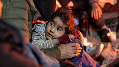 Immigrants from Afghanistan stay warm by a campfire at a transit camp at the US-Mexico border near Sasabe, Arizona. (Getty Images via AFP) Immigrants from Afghanistan stay warm by a campfire at a transit camp at the US-Mexico border near Sasabe, Arizona. (Getty Images via AFP)