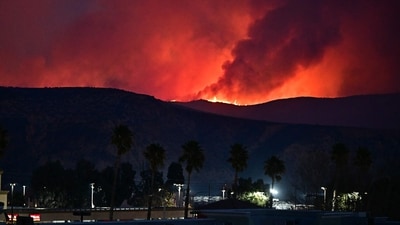  The fire was being fanned by strong, dry Santa Ana winds that were racing through the area, pushing a vast pall of smoke and embers ahead of the flames. Evacuations were ordered for 19,000 people all around the lake, which sits around 35 miles north of Los Angeles, and close to the city of Santa Clarita. (AFP/Frederic J. Brown ) The fire was being fanned by strong, dry Santa Ana winds that were racing through the area, pushing a vast pall of smoke and embers ahead of the flames. Evacuations were ordered for 19,000 people all around the lake, which sits around 35 miles north of Los Angeles, and close to the city of Santa Clarita. (AFP/Frederic J. Brown )